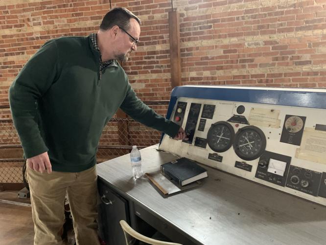 Walt Chadick operates an elevator leading up to the "great refractor" telescope