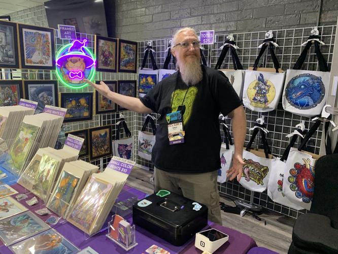 Professional artist Chet Minton proudly displays some of his items during EGG Con II