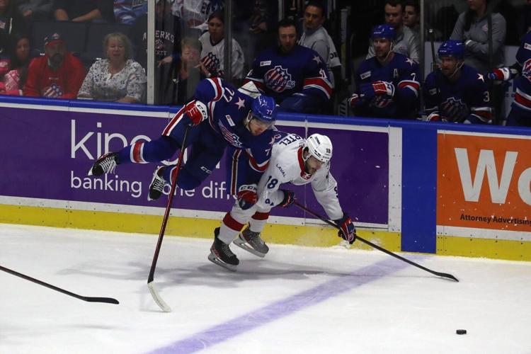 Rochester Amerks JJ Peterka (77) gets checked and goes over Laval's Danick Martel (18)