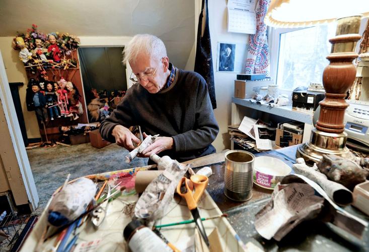 Ken Vogel working on puppet in his apartment