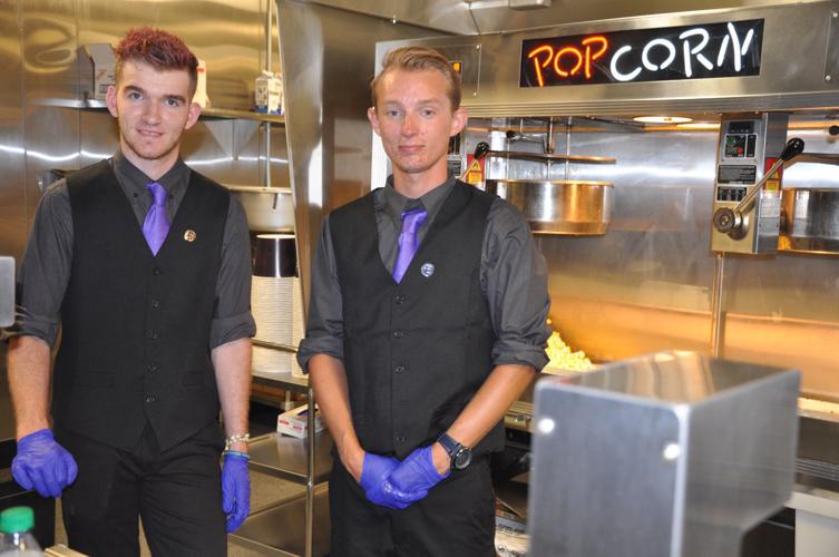 Concession stand workers Brandon Johnson and David Coletti prepare to serve patrons