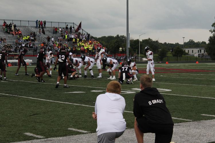 Youth football players learn from the sidelines
