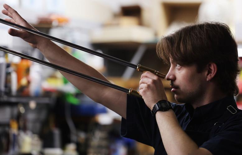 Ward-Brodt technician Steven Conradt fixes a trombone