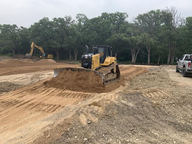 A dirt path is being paved to start the Plas-tech Engineering expansion project