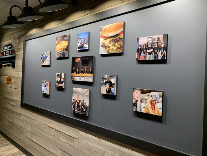 Clock Tower Pizza features a photo wall with pictures of the previous Lake Geneva location and some of the menu items