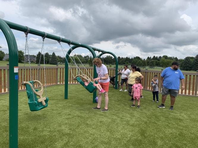 Children enjoy playing on the swings at Never Say Never Playland