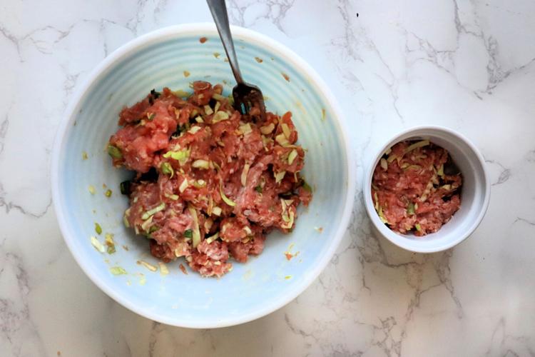 1/4 cup of pork mixture is portioned into the bottom of a 6-ounce ramekin.