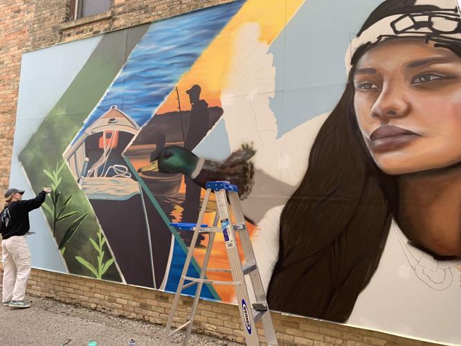 A mural depicting Native American history, nature areas and recreational activities in the Lake Geneva area has been painted on 234 Broad St. building