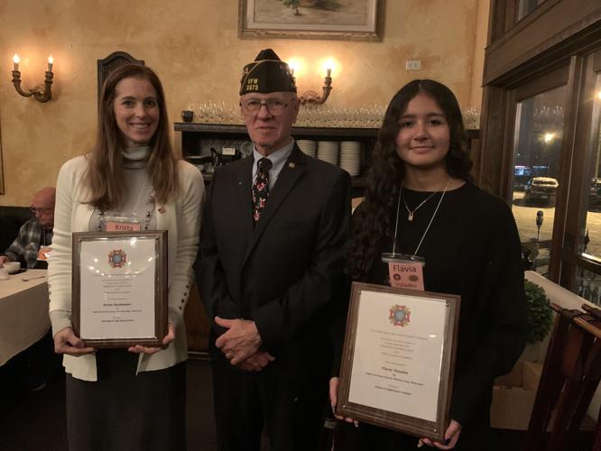 Krista Bensheimer, Ronald Grabski and Flavia Valadez pose for a photo after the annual Christmas party and awards dinner