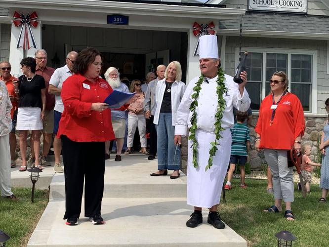 VISIT Lake Geneva President and CEO Stephanie Klett congratulates Chef John Bogan on the new location for his cooking school