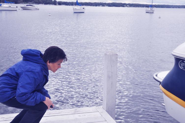 New Harbormaster Linda Frame closely examines a boat docked at the west end pier