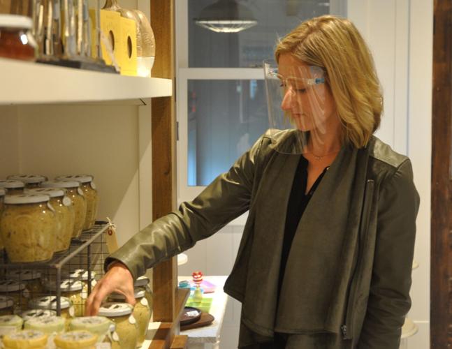 Monika Stinebrink, Marketplace employee, sorts through some home-decor items that are offered at the store