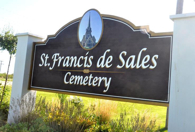 Members of the St. Francis de Sales Cemetery Committee recently installed a sign