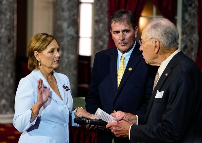 Darline Graham Nordone, left, standing with her husband Larry Nordone, takes part in a ceremonial swearing-in as a U.S. Senator