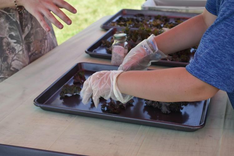 Student prepares kale chips at YMCA