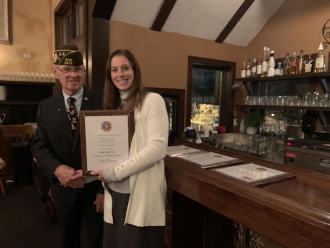Geneva Lake VFW Post 2373 Commander Ronald Grabski presents Krista Bensheimer with the Teacher of the Year Award
