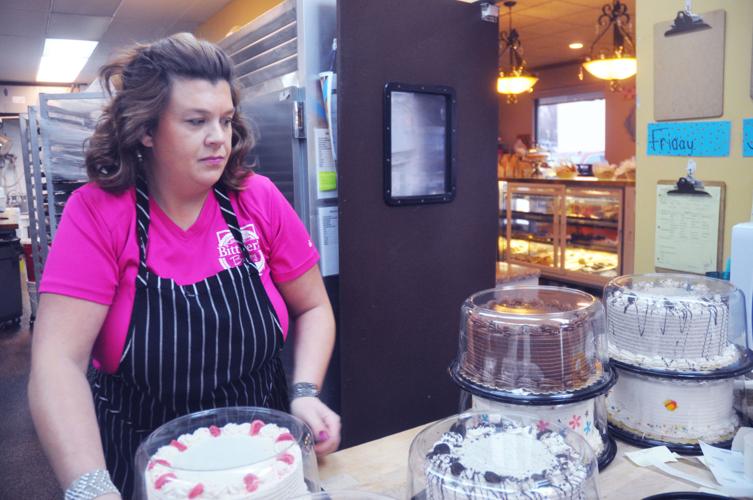 Amy Peterburs-Bittner places cakes into plastic containers