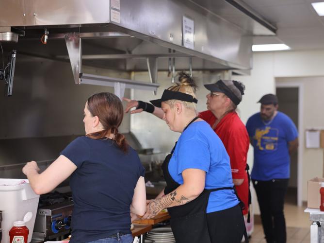 Cooking burgers for hungry Brewers fans