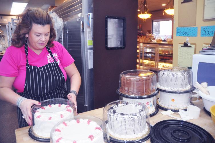 Amy Peterburs-Bittner begins to place some already-made cakes into containers