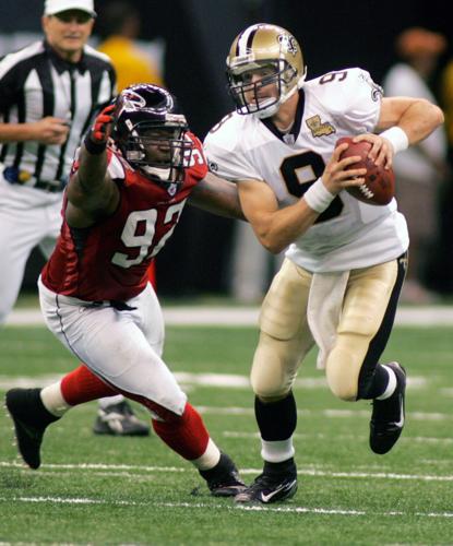 New Orleans Saints quarterback Brees scrambles away from Atlanta Falcons defensive end Kerney in New Orleans