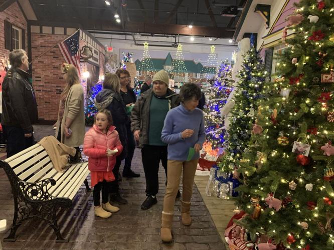 A crowd of people enjoy viewing the decorated trees during a special event that was held, Nov. 18