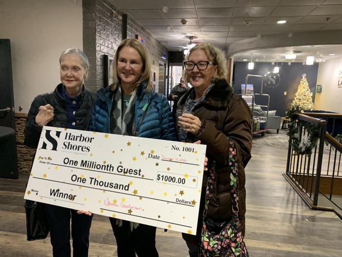 Diana Thompson, center, poses with her $1,000 check with her two sisters, Gail Thompson and Sharon Groot
