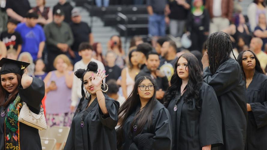 Graduates wave to families