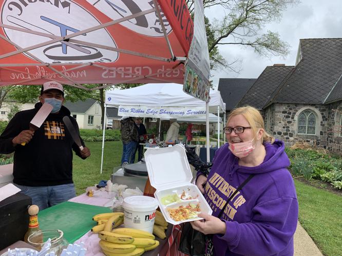 Stephanie King of Lake Geneva enjoys some crepes made by Kevin Martinez of Magic Crepes