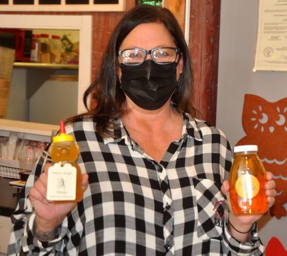 Wendi Koenen, store manager at The Farmstand, display some of the honeys that she provides for the store