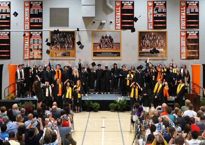 Graduates toss their mortarboards in celebration at the Williams Bay High School Class of 2023 commencement ceremony