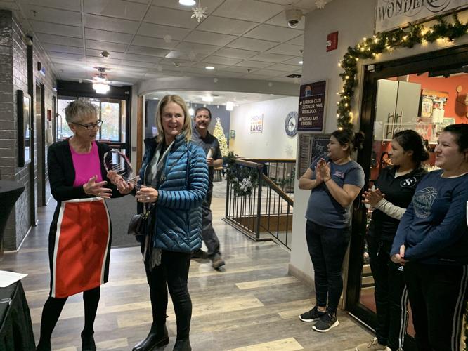 Tammie Carstensen, presents Diana Thompson with a plaque for being the hotel's one millionth guest