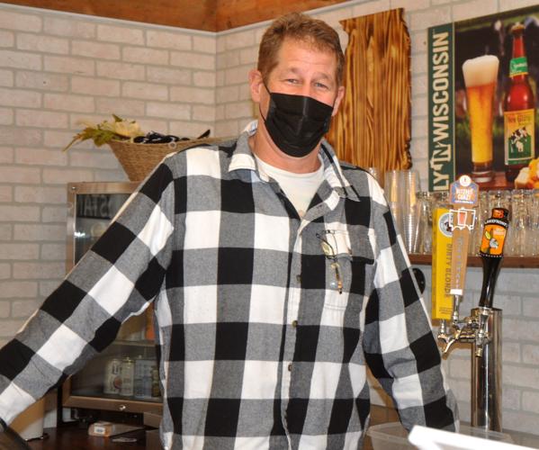 Daniel Robers, co-owner of The Farmstand, stands behind the bar area of the business, which features locally-crafted beers