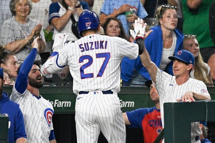 Chicago Cubs right fielder Seiya Suzuki (27) high fives Chicago Cubs manager Craig Counsell (11) right, after his two-run home run during the third inning against the Detroit Tigers at Wrigley Field in Chicago on Monday, July 20, 2026.