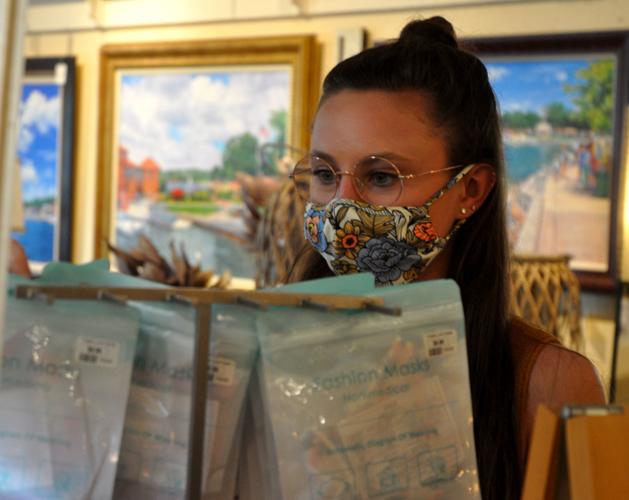 Kelsey Bedlre, Cornerstone Shop & Gallery employee, arranges some facemasks