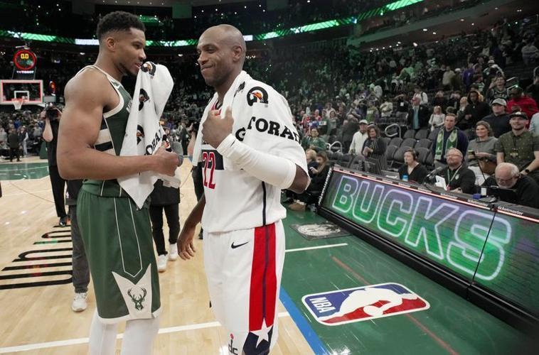 Milwaukee Bucks forward Giannis Antetokounmpo and Washington Wizards forward Khris Middleton talk after their game.