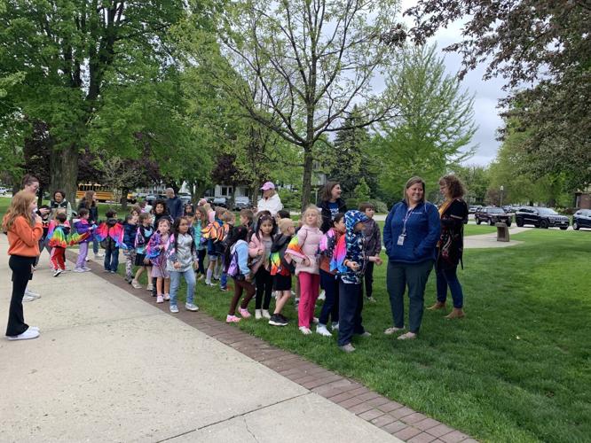 A group of Central-Denison Elementary School students arrive to the ribbon-cutting ceremony for the launch of the Monarch Habitat Garden
