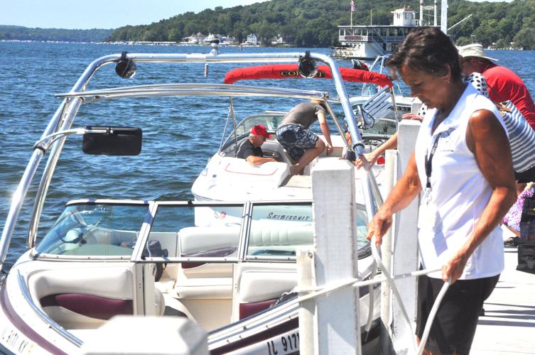 Harbormaster Linda Frame guides a boat into Geneva Lake