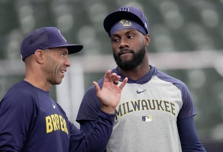 Milwaukee Brewers first base coach Spencer Allen, left, talks with outfielder Akil Baddoo before their game against the New York Yankees Sunday, May 10, 2026 at American Family Field in Milwaukee, Wisconsin.