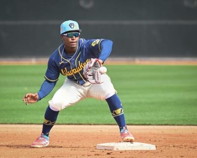 Milwaukee Brewers infield prospect Luis Pena takes a throw in a double-play drill during spring training workouts Sunday, February 15, 2026, at American Family Fields of Phoenix in Phoenix, Arizona.