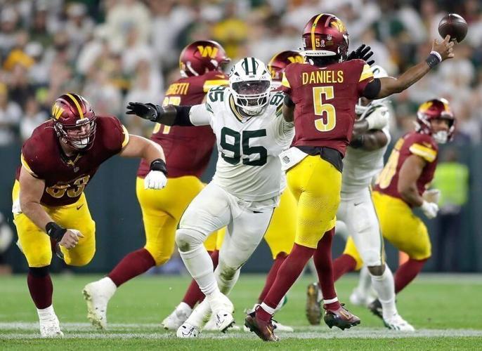 Sep 11, 2025; Green Bay, Wisconsin, USA; Green Bay Packers defensive tackle Devonte Wyatt (95) pressures Washington Commanders quarterback Jayden Daniels (5) at Lambeau Field. Mandatory Credit: Wm. Glasheen-USA TODAY Network via Imagn Images