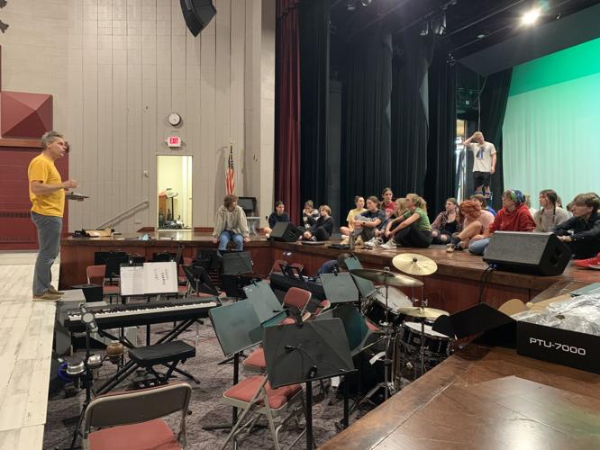Director Andrew Stoltenberg talks to his cast members during a break