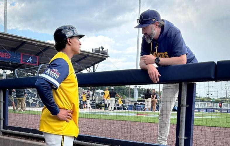 Catcher Bo Naylor, serving as the 27th man for the Milwaukee Brewers at the Little League World Series Classic, talks with hitting coach Eric Theisen on Sunday, August 23, 2026, at Bowman Field in Williamsport, Pennsylvania.