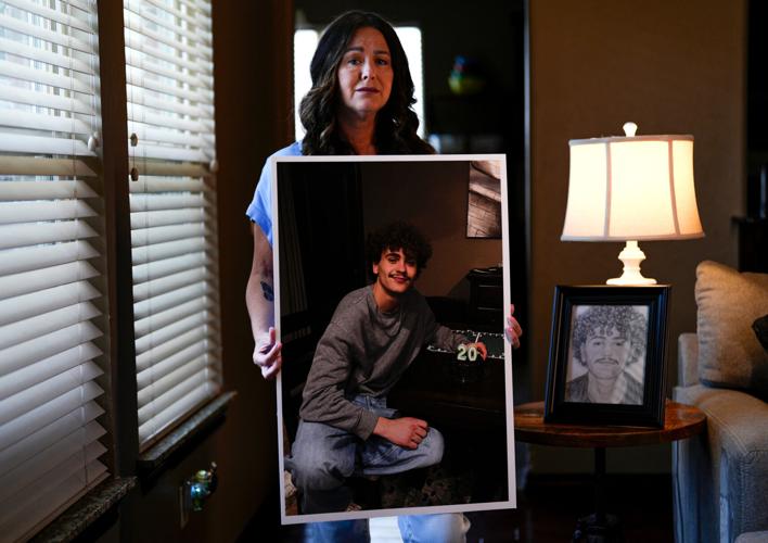 Miranda Bartholomew holds a picture of her son, Evan Bartholomew, inside her home in Moore, Okla., Friday, July 17, 2026. Evan Bartholomew died after taking synthetic form of kratom.