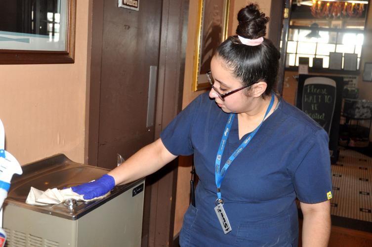 Vanessa Flores and other Harbor Shore hotel employees are cleaning all areas of the hotel