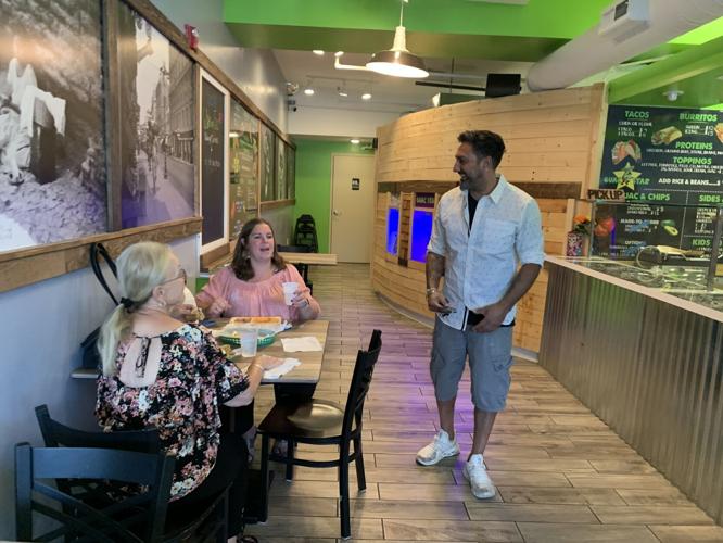Kevin Singh greets customers at his restaurant, Guac Star