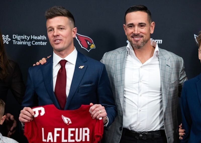 Arizona Cardinals coach Mike LaFleur, left, and brother and Green Bay Packers coach Matt LaFleur pose at an introductory news conference at the Cardinals training facility.