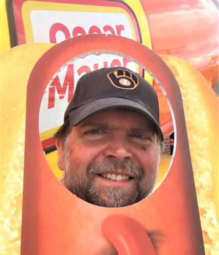 Lake Geneva Regional News columnist Eric Johnson comes up a wiener during the Oscar Mayer Wienermobile's Aug. 18stop at Daniels Foods, Walworth