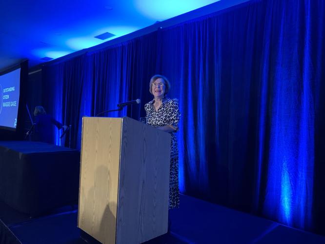 Maggie Gage proudly accepts the outstanding citizen award