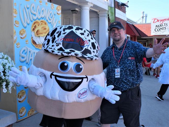 Lake Geneva Regional News columnist Eric A. Johnson with Wisconsin State Fair cream puff mascot Cravin' D. Creampuff