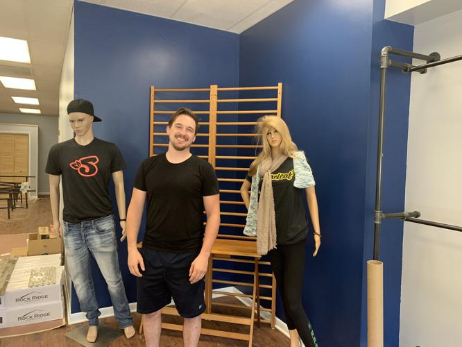 Tyler Dempsey, owner of Holistic Connections in Lake Geneva, stands next to some mannequins